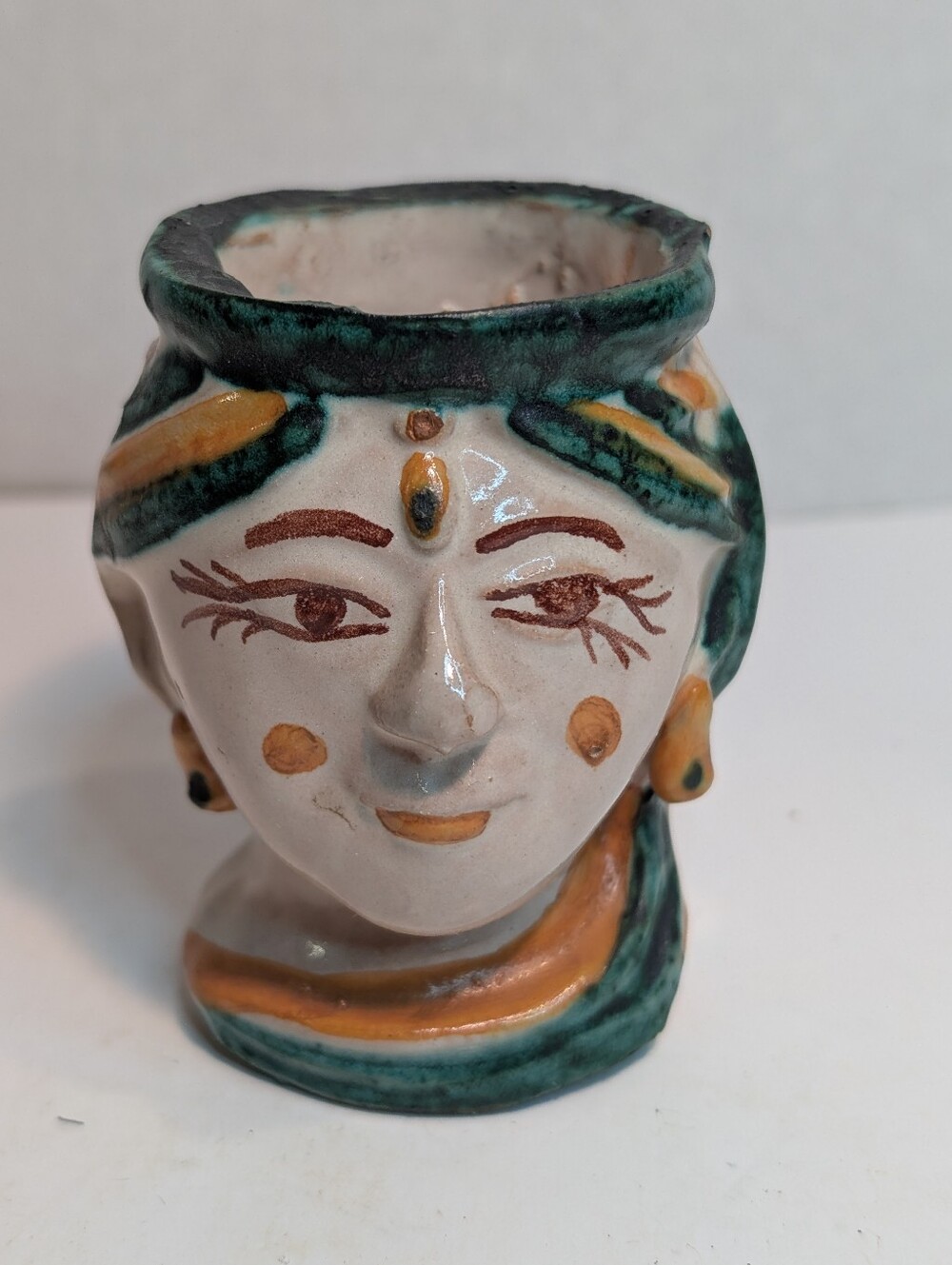 A small, hand-painted ceramic head vase in traditional Sicilian Testa di Moro.